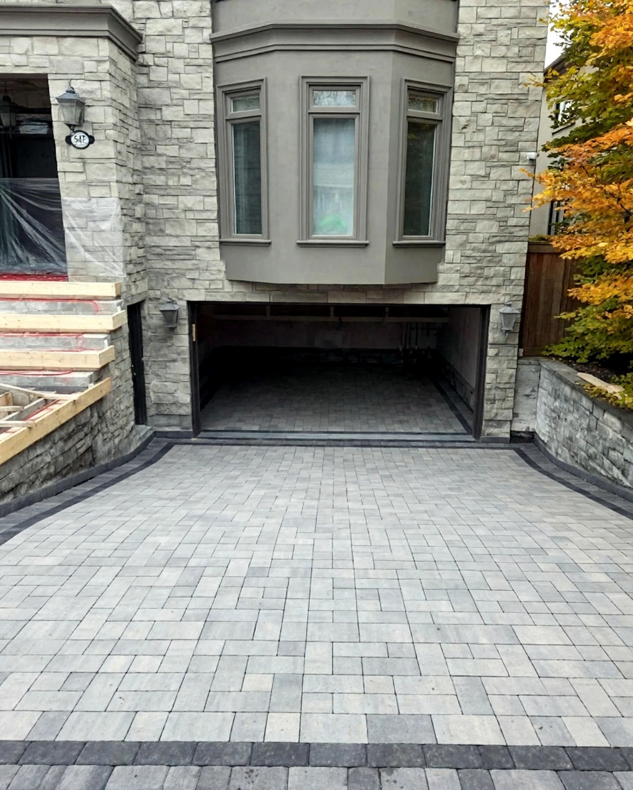 Design concept — finished heated walkway visualization with light-grey interlock pavers and charcoal border accents